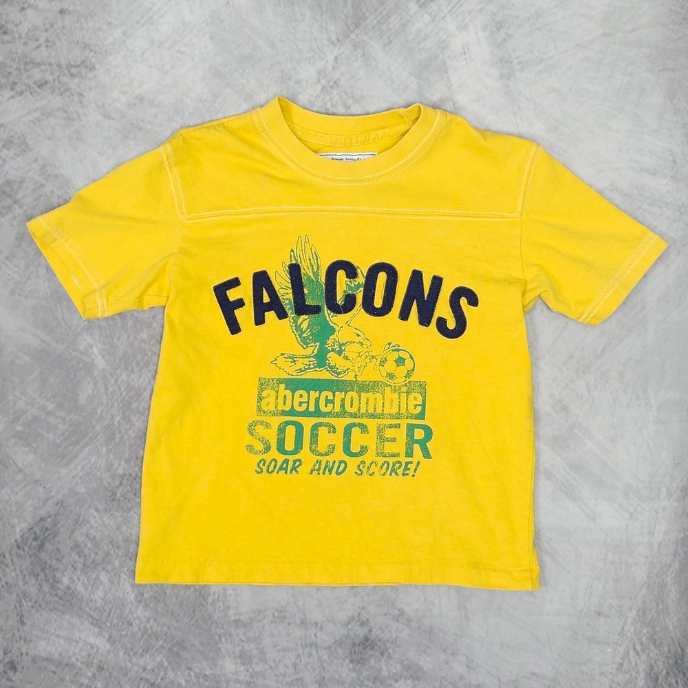 Vintage Abercrombie Kids Falcons Soccer Graphic T Shirt Yellow Kids S / Baby Tee